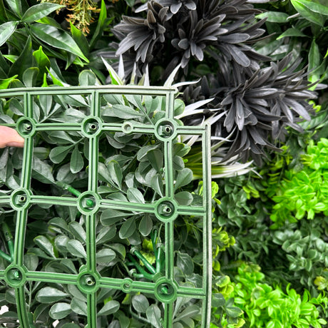 Artificial green wall panel with variegated greens of ivy, ferns, palm heads, grasses & yellow tipped privets 100x100 cm