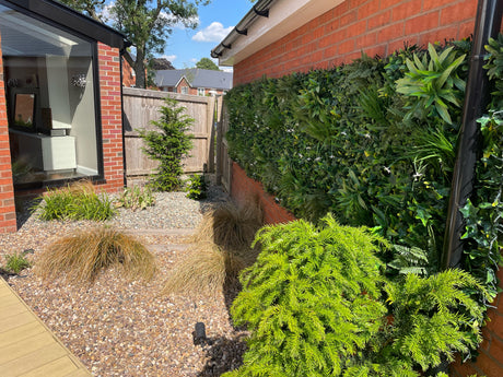 Artificial green wall panel with variegated greens of ivy, ferns, palm heads, grasses & yellow tipped privets 100x100 cm