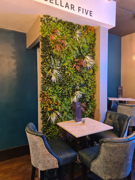 Artificial green wall panel with mixed green orange red and white foliage, white and yellow flowers 100x100 cm